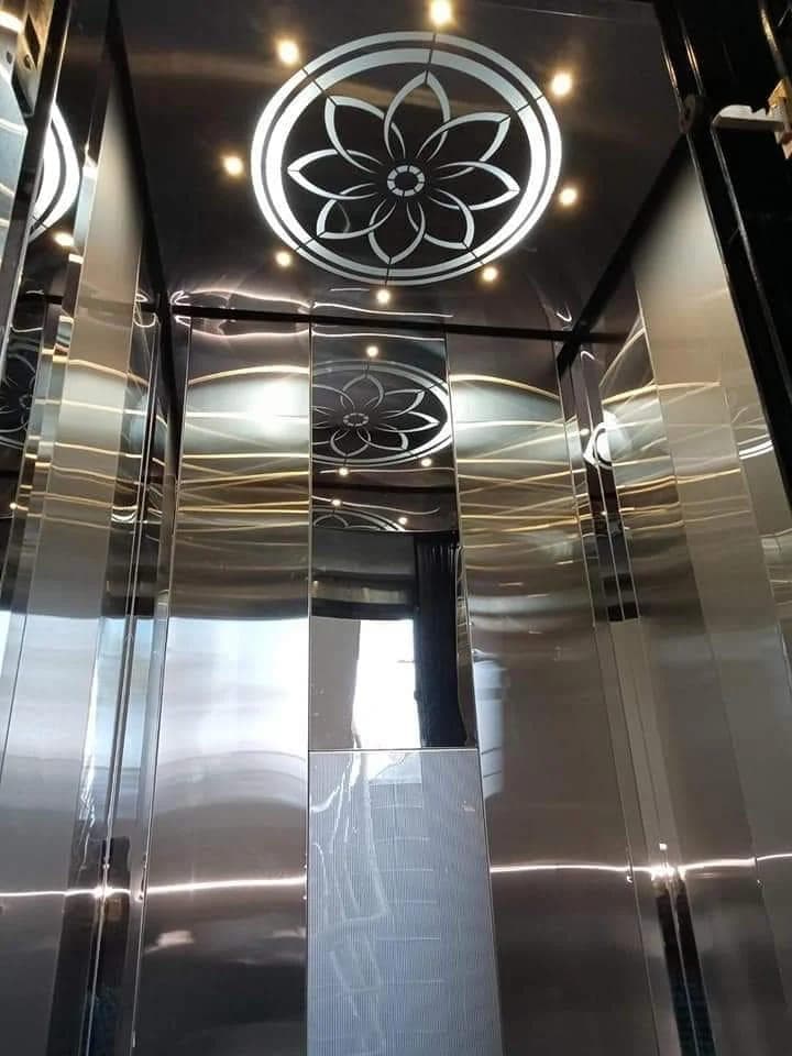 Mirror-finish elevator cabin with decorative floral ceiling
